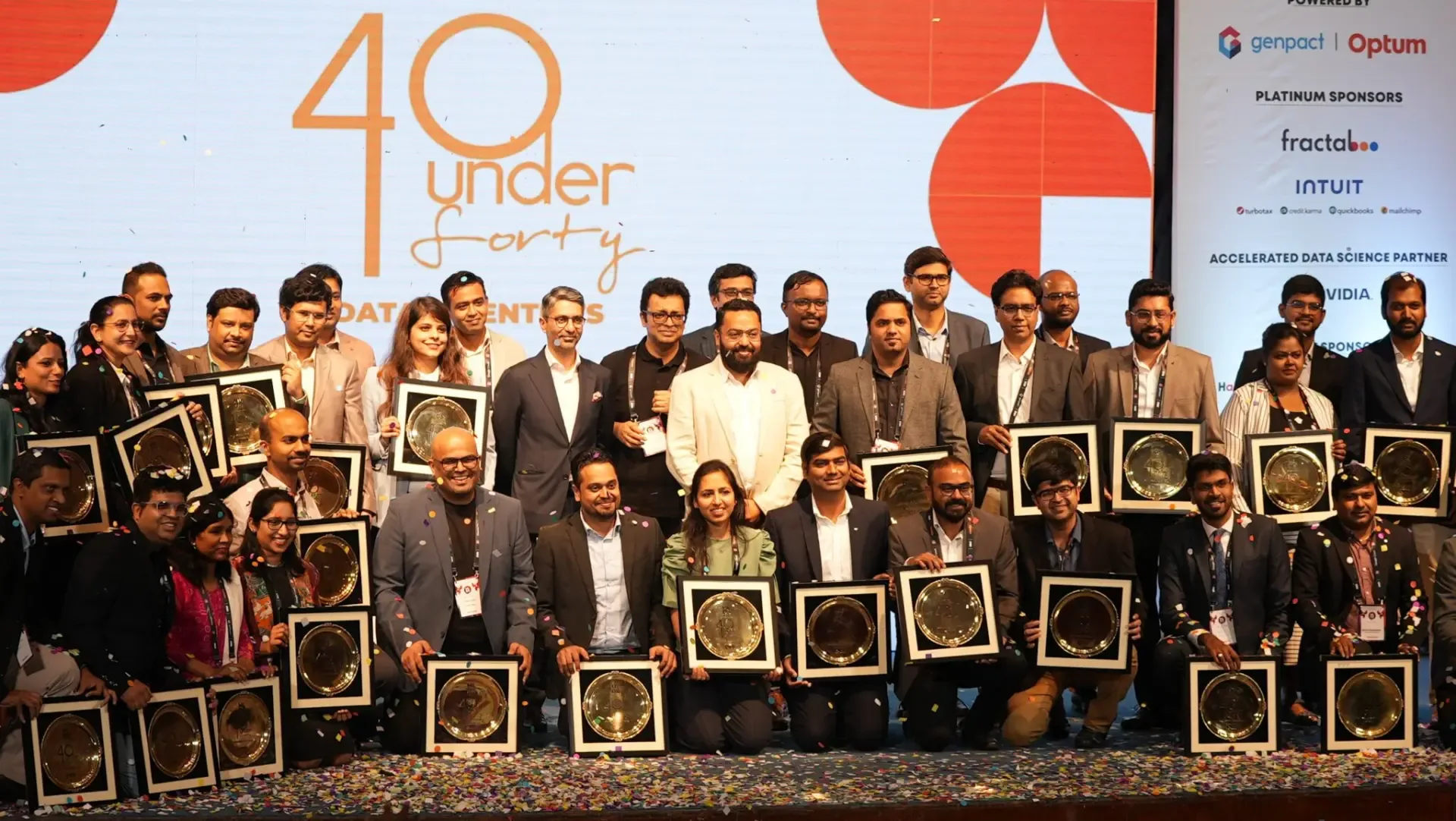40 Under 40 honorees holding their trophies