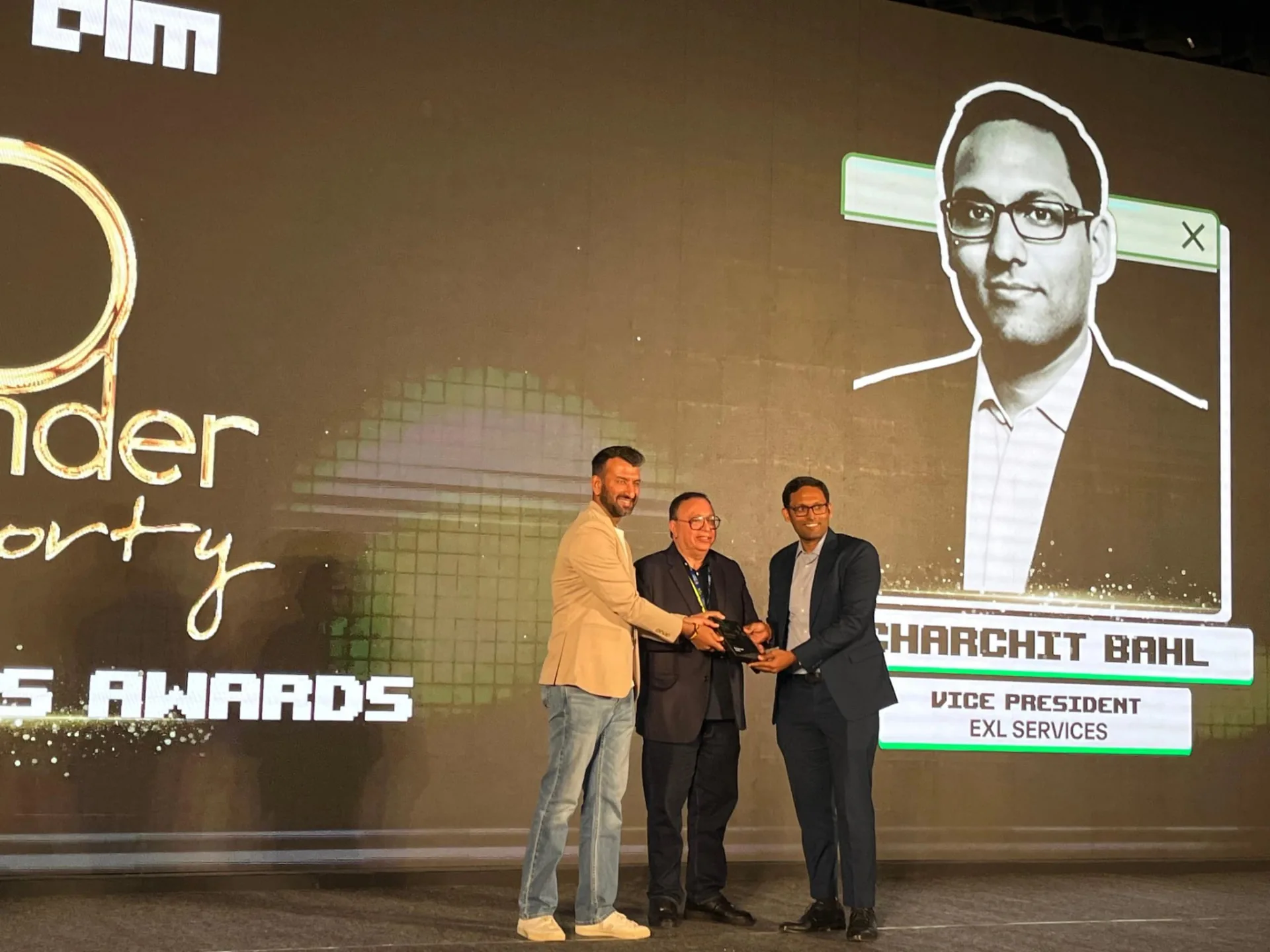 An honoree receiving the 40 Under 40 award on stage